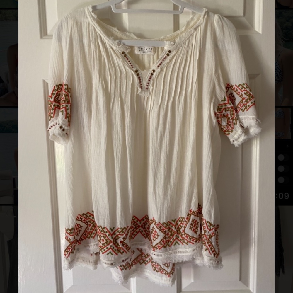 cream colored shirt with pretty sewed in designs